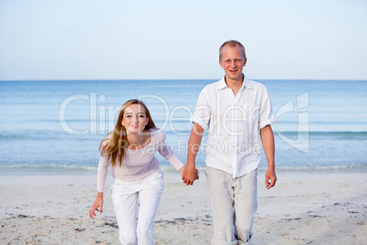 happy couple in love having fun on the beach