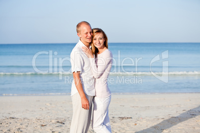 happy couple in love having fun on the beach