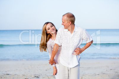happy couple in love having fun on the beach