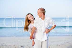 happy couple in love having fun on the beach