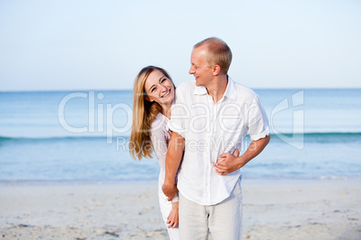 happy couple in love having fun on the beach