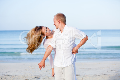 happy couple in love having fun on the beach