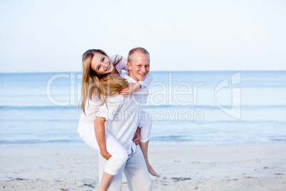 happy couple in love having fun on the beach