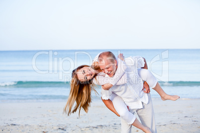 happy couple in love having fun on the beach