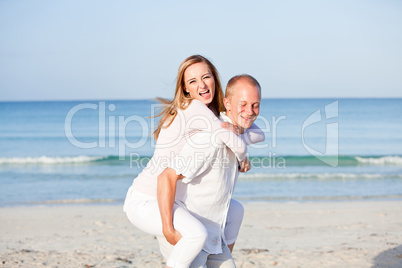 happy couple in love having fun on the beach