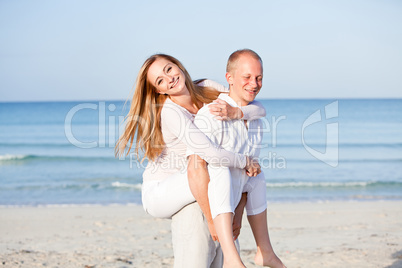 happy couple in love having fun on the beach