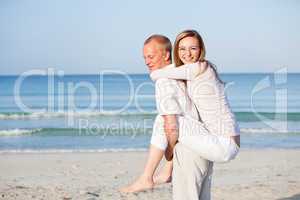 happy couple in love having fun on the beach