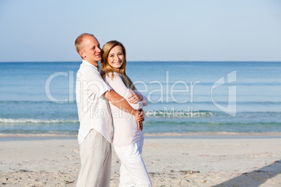 happy couple in love having fun on the beach