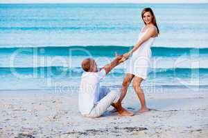 happy couple in love having fun on the beach