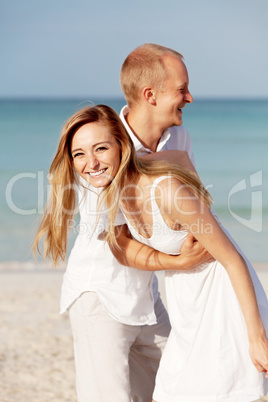 happy couple in love having fun on the beach