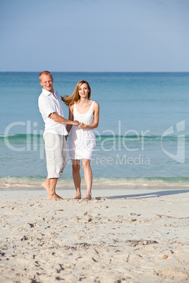 happy couple in love having fun on the beach