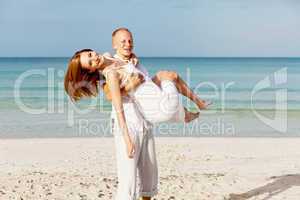 happy couple in love having fun on the beach