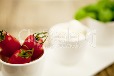 tasty tomatoes mazarella and basil on plate on table