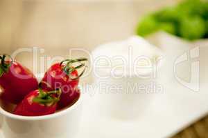 tasty tomatoes mazarella and basil on plate on table