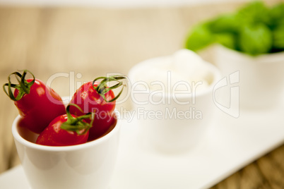 tasty tomatoes mazarella and basil on plate on table