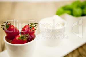 tasty tomatoes mazarella and basil on plate on table