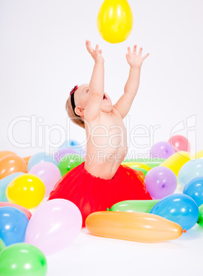 cute little baby child with colorfull balloons birthday
