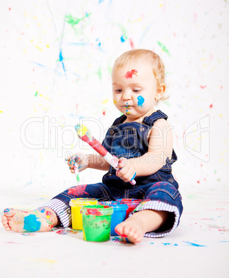 cute little baby painting and splatter with colours