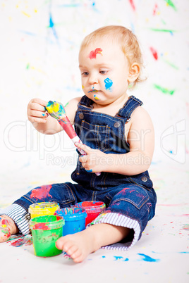cute little baby painting and splatter with colours