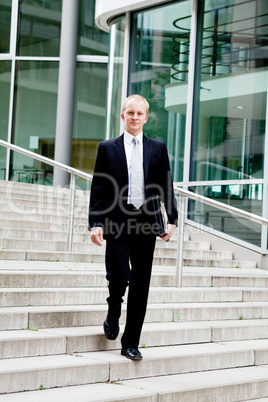 young business man in black suit with tie outdoor