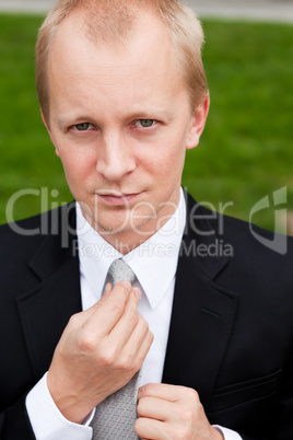 business man with black suit and tie outdoor