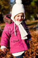 cute littloe girl playing outdoor in autumn
