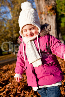 cute littloe girl playing outdoor in autumn