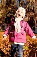 cute little child playing outdoor in autumn