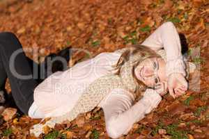 young smiling woman with hat and scarf outdoor in autumn