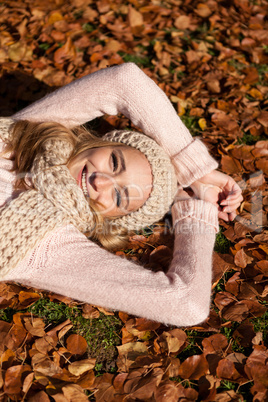 young smiling woman with hat and scarf outdoor in autumn