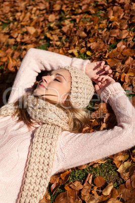 young smiling woman with hat and scarf outdoor in autumn