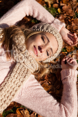 young smiling woman with hat and scarf outdoor in autumn