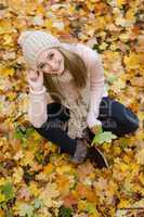 attractive young woman relaxing in atumn park outdoor