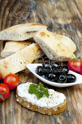 green olives with fresh bread and herbs