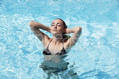 beautiful woman in summer in pool swimming
