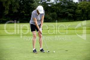 woman is playing golf on course  summer
