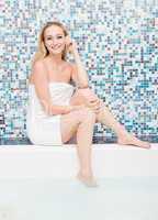 blonde woman with towel in a whirlpool spa