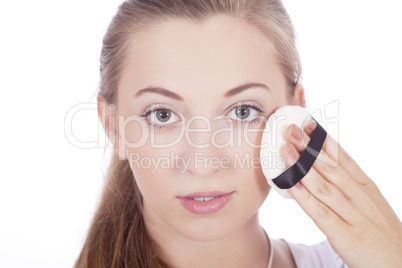 young beautiful woman applying mineral powder