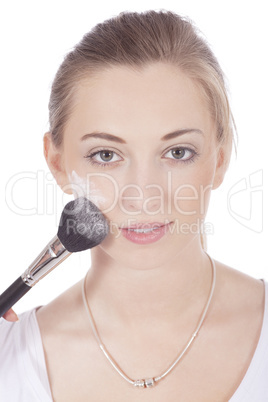 young beautiful woman applying mineral powder