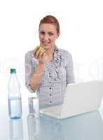 young business woman on computer with snack isolated