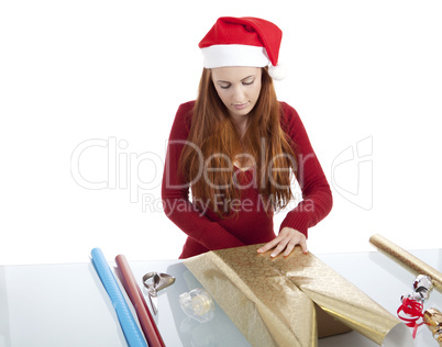young woman is packing  present for christmas isolated