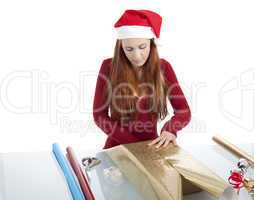 young woman is packing  present for christmas isolated