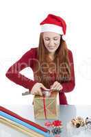 young woman is packing  present for christmas isolated