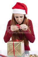 young woman is packing  present for christmas isolated