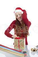 young woman is packing  present for christmas isolated