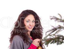beautiful brunette woman is decorating a christmas tree