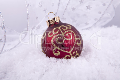 beautiful gold and red christmas decoration on white snow