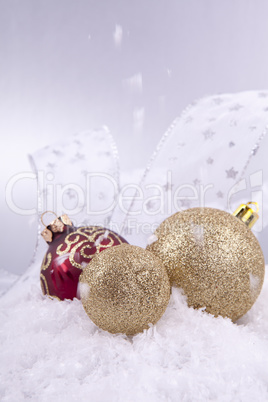 beautiful gold and red christmas decoration on white snow