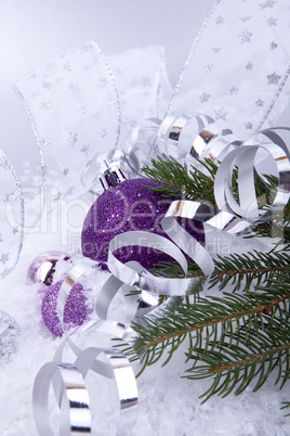 beautiful christmas decoration in purple and silver on white snow