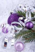 beautiful christmas decoration in purple and silver on white snow
